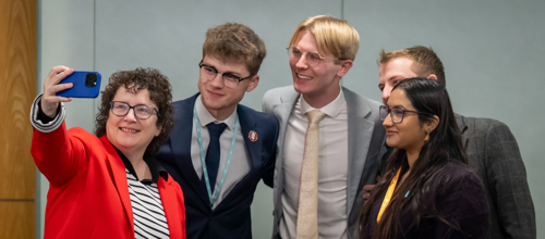 the Llywydd taking a selfie with past and present WYP members