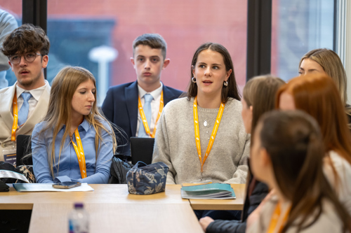 Members stat at a table